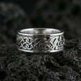 Load image into Gallery viewer, Polished silver Viking Celtic knot wedding band displayed on volcanic stone background highlighting clean edges and continuous infinity weave
