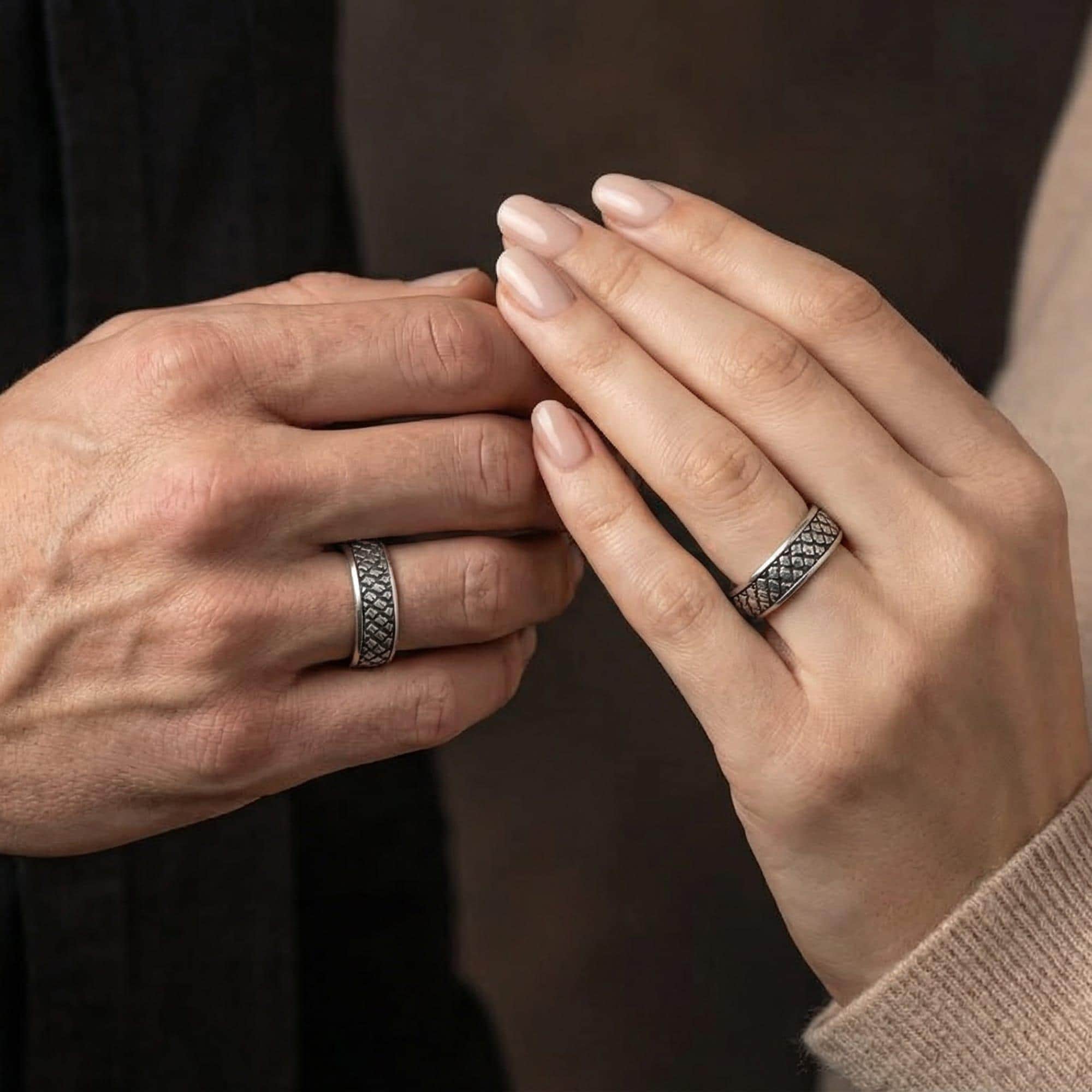 Oxidized Japanese cloud relief band ring worn on finger of a man and woman as a statement piece, emphasizing darkened depth and traditional swirl pattern definition