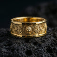 Load image into Gallery viewer, Gold plated lion head signet-style band ring showcased on volcanic rock emphasizing regal guardian symbolism and heritage ring aesthetic
