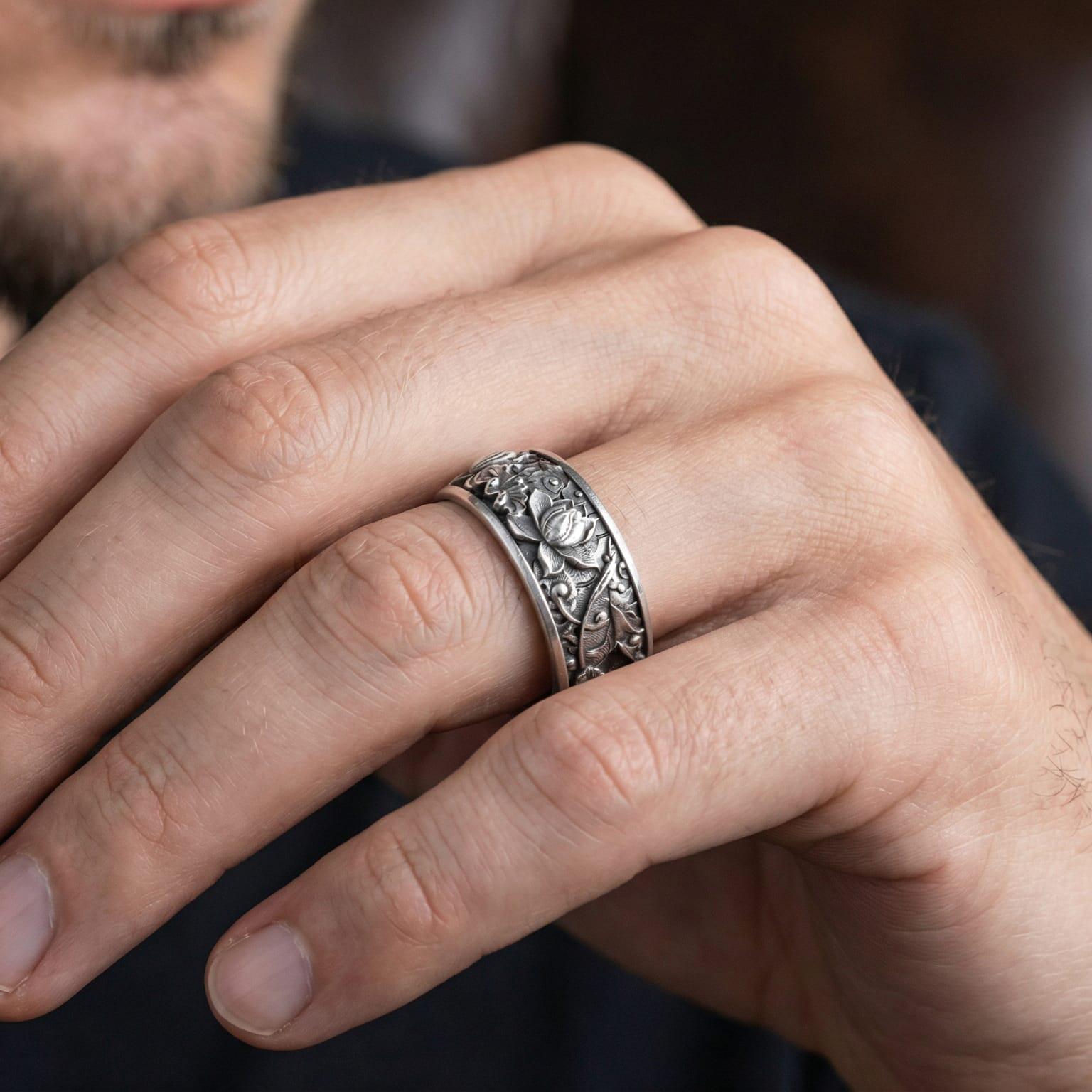 Oxidized lotus flower engraved ring worn on finger as a spiritual statement band for yoga, meditation, and everyday wear