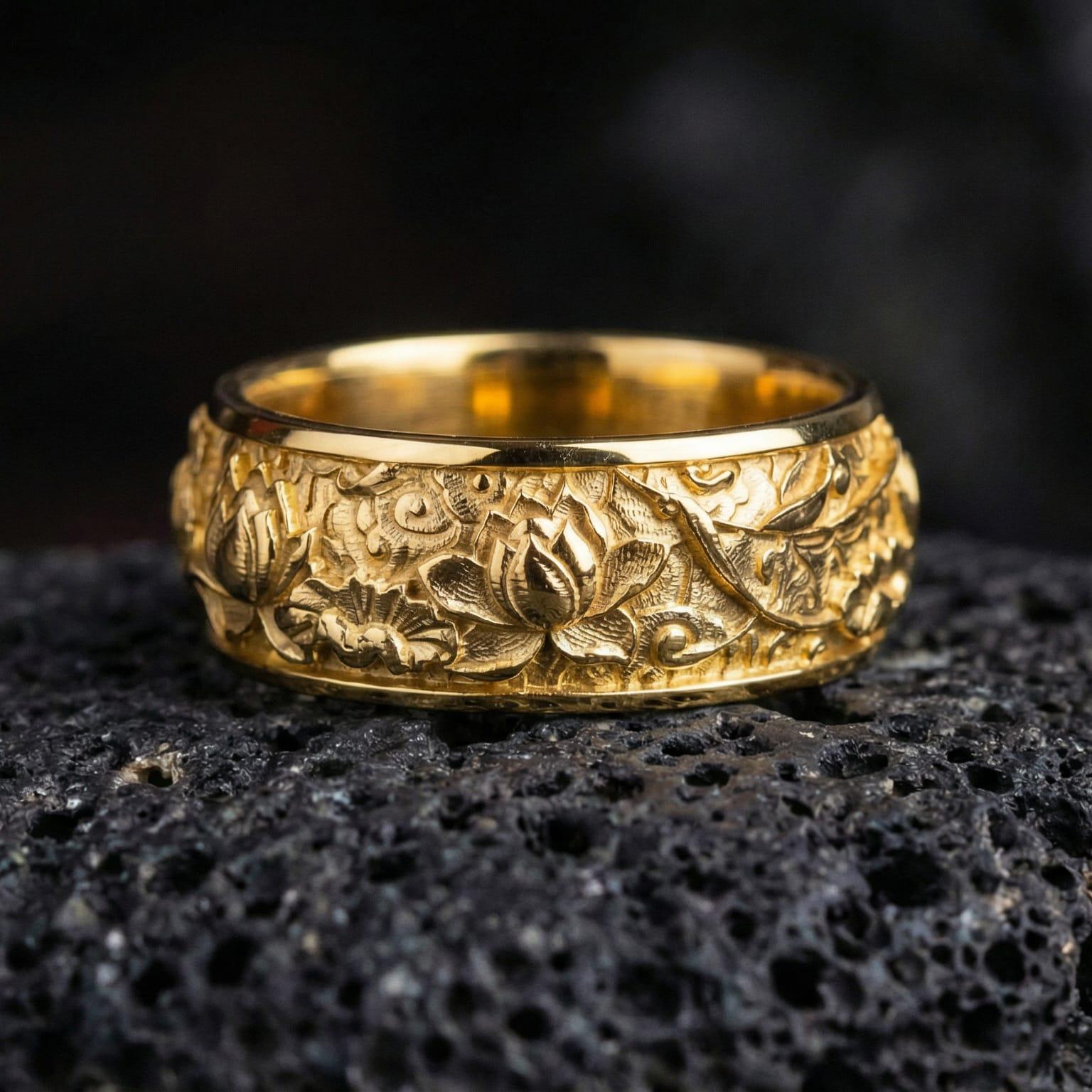 Gold plated lotus flower carved ring showcased on volcanic rock as a symbol of rebirth, calm energy, and mindful style