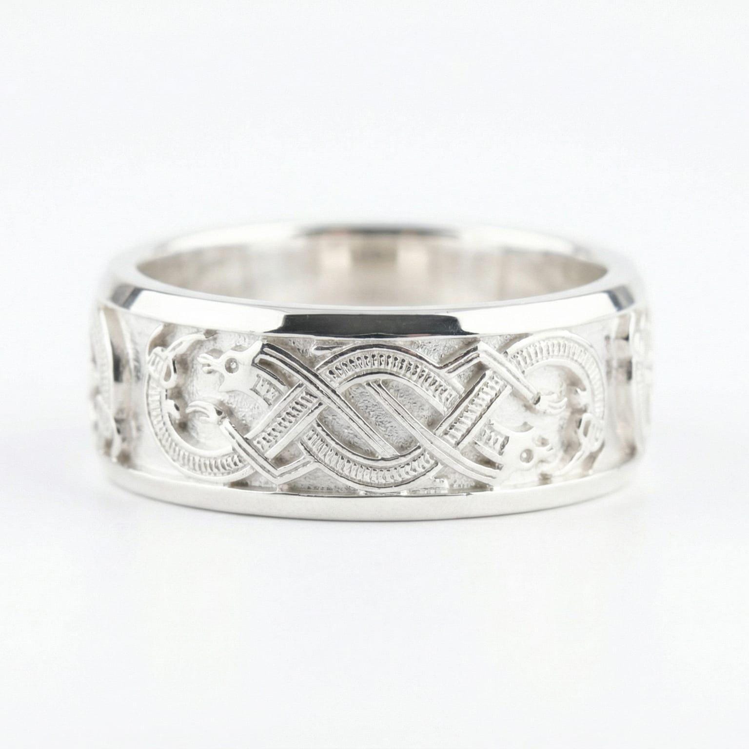 White Gold Slavic dragon motif ring displayed on a white surface highlighting Celtic-style knot details and bold mythology aesthetic