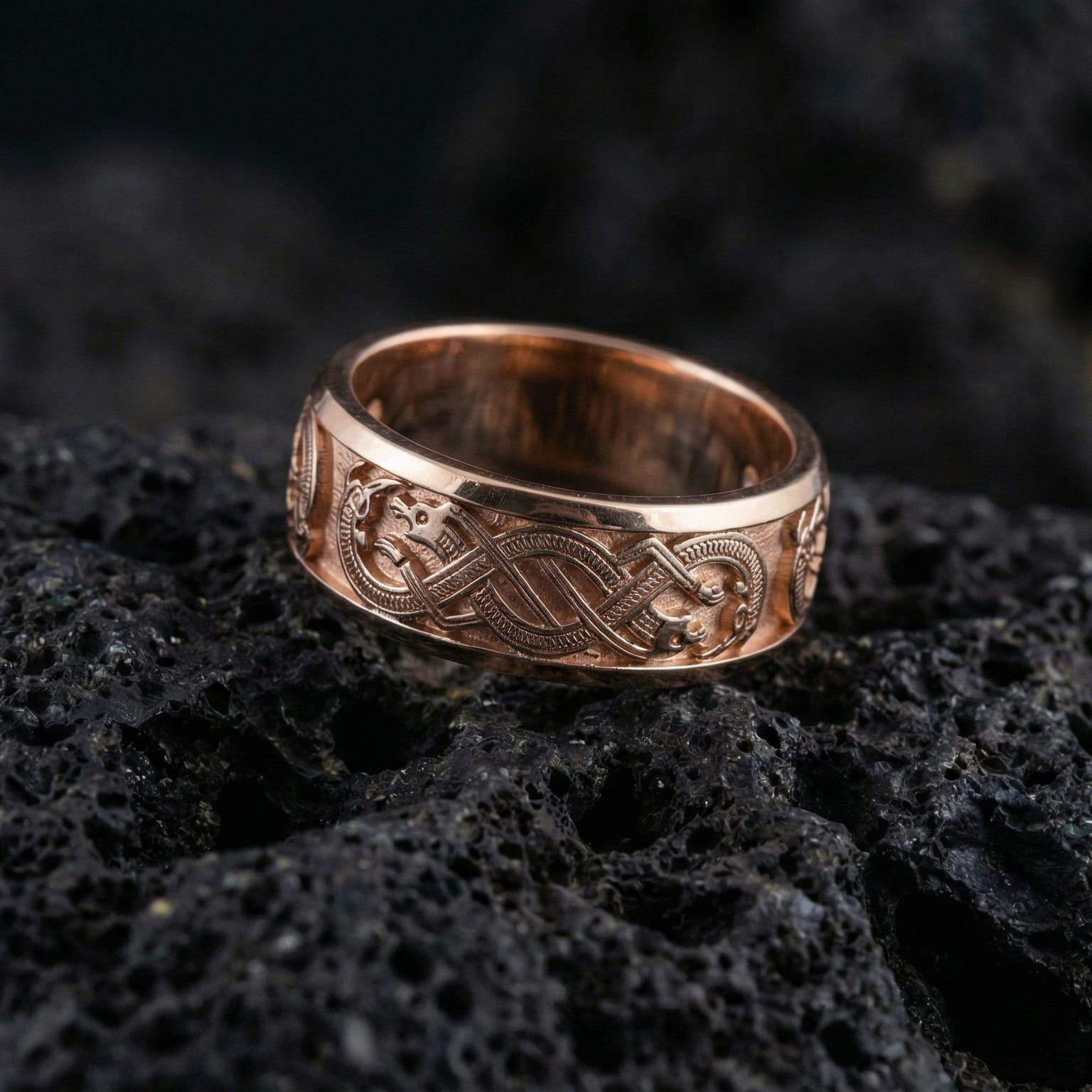 Rose Gold Slavic dragon motif ring displayed on volcanic rock highlighting Celtic-style knot details and bold mythology aesthetic