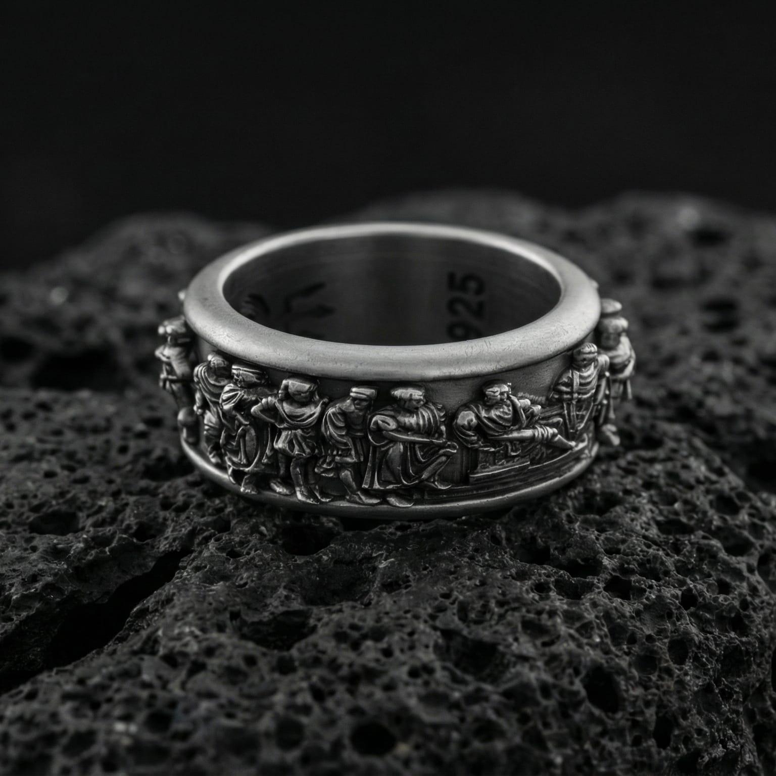 Oxidized sterling silver spinner fidget Greek crowd ring photographed on volcanic rock with high-relief ancient procession engraving