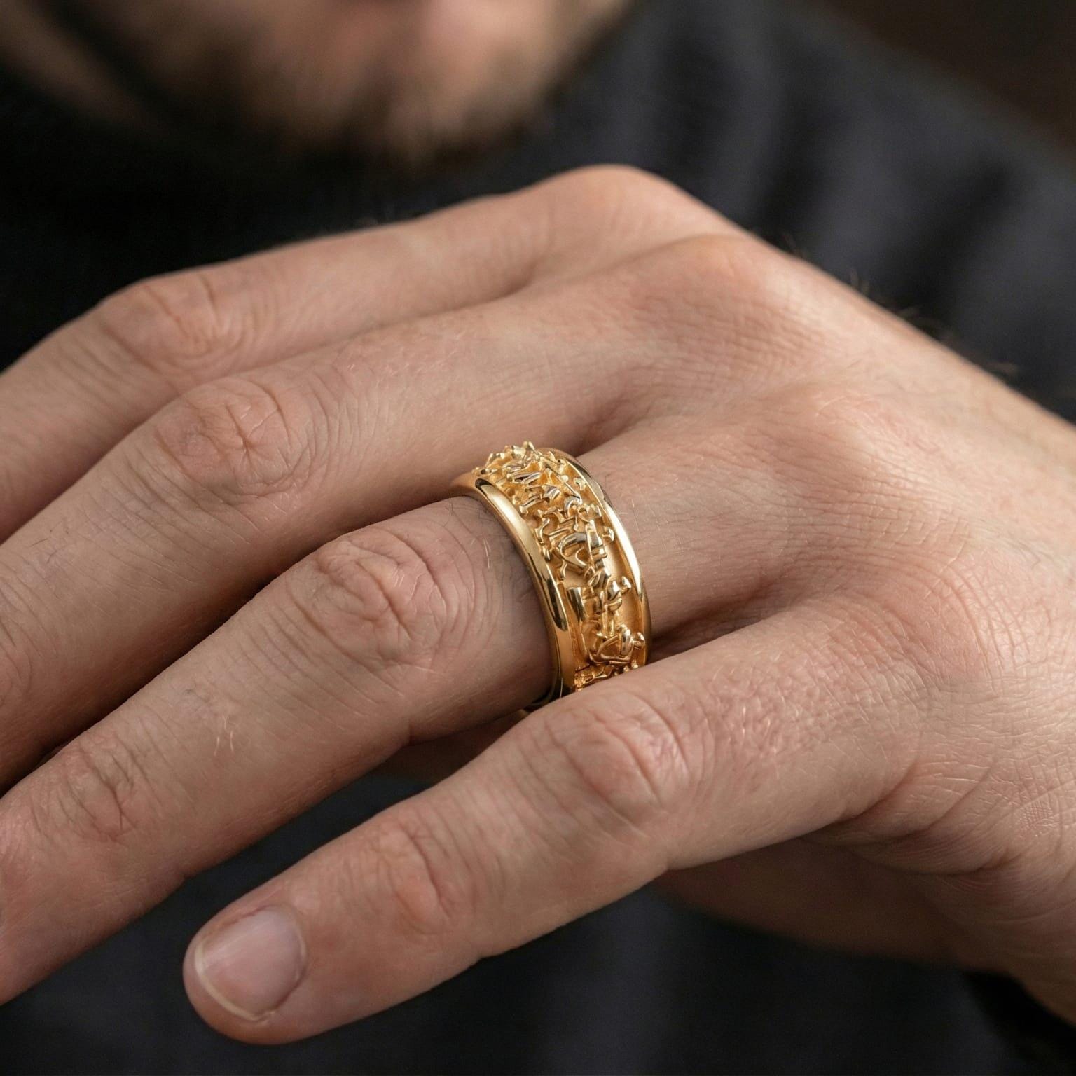 Gold plated Greek procession spinner ring worn by model as a luxury heritage statement piece with strong masculine presence