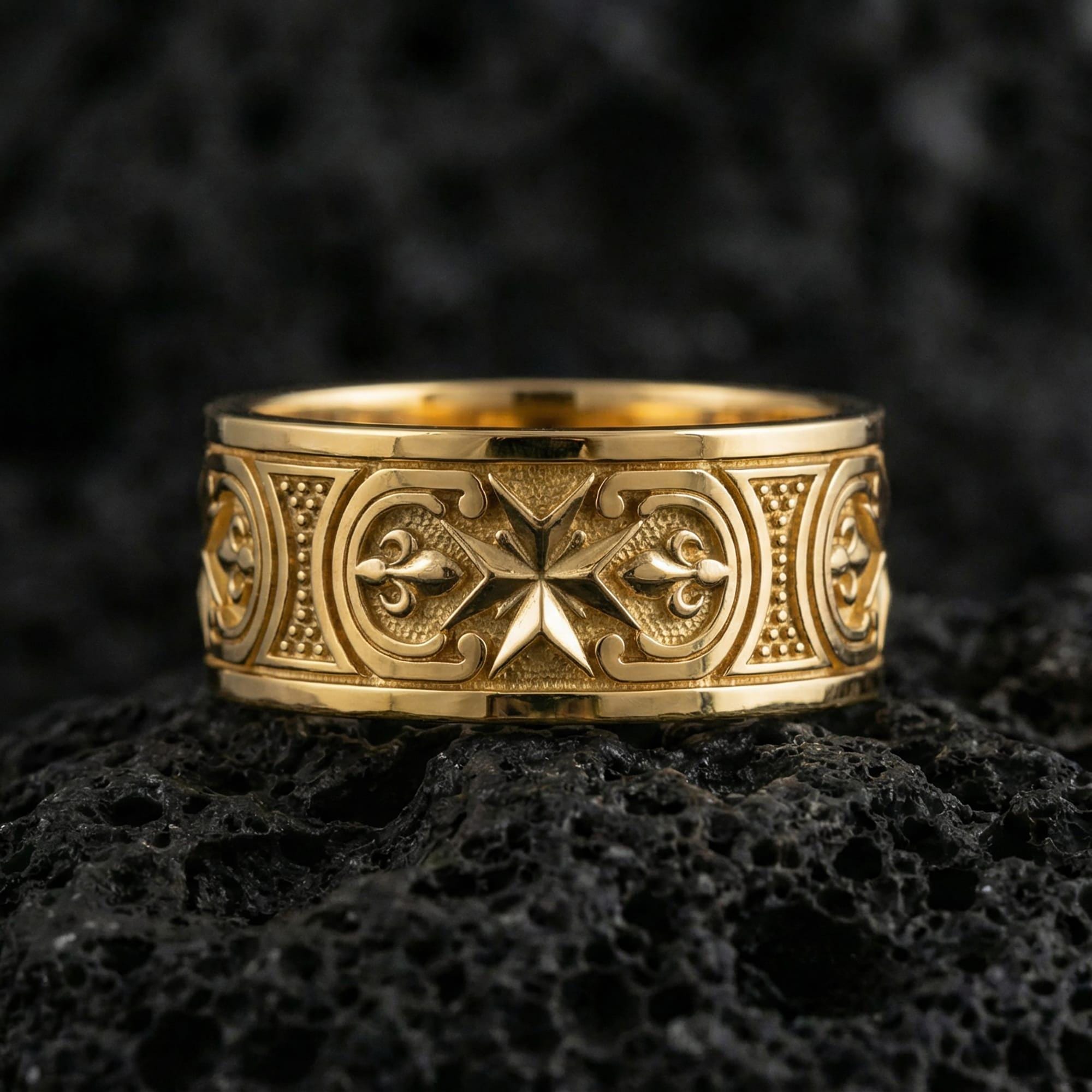 Gold plated Knights Hospitaller Maltese cross wedding band showcased on volcanic rock with heritage-inspired fleur de lis pattern and bold masculine profile