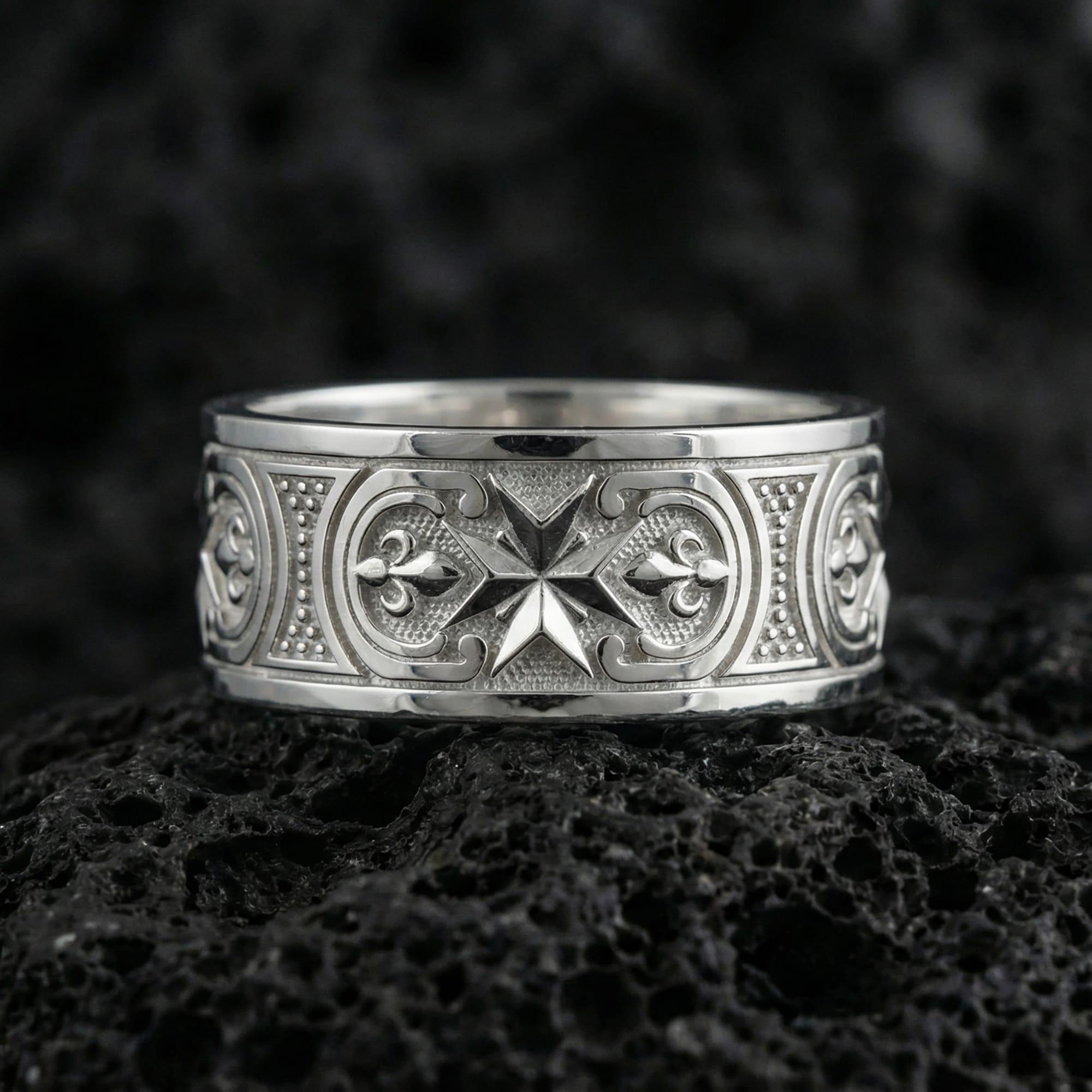 White Gold Knights Hospitaller Maltese cross wedding band showcased on volcanic rock with heritage-inspired fleur de lis pattern and bold masculine profile