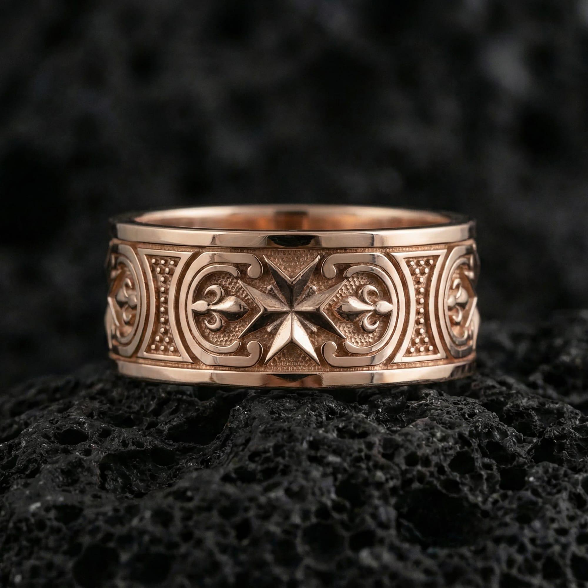 Rose Gold Knights Hospitaller Maltese cross wedding band showcased on volcanic rock with heritage-inspired fleur de lis pattern and bold masculine profile