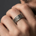 Load image into Gallery viewer, Oxidized wave pattern sterling silver ring worn on finger as a rugged everyday wedding band with artisan-carved swirl detail
