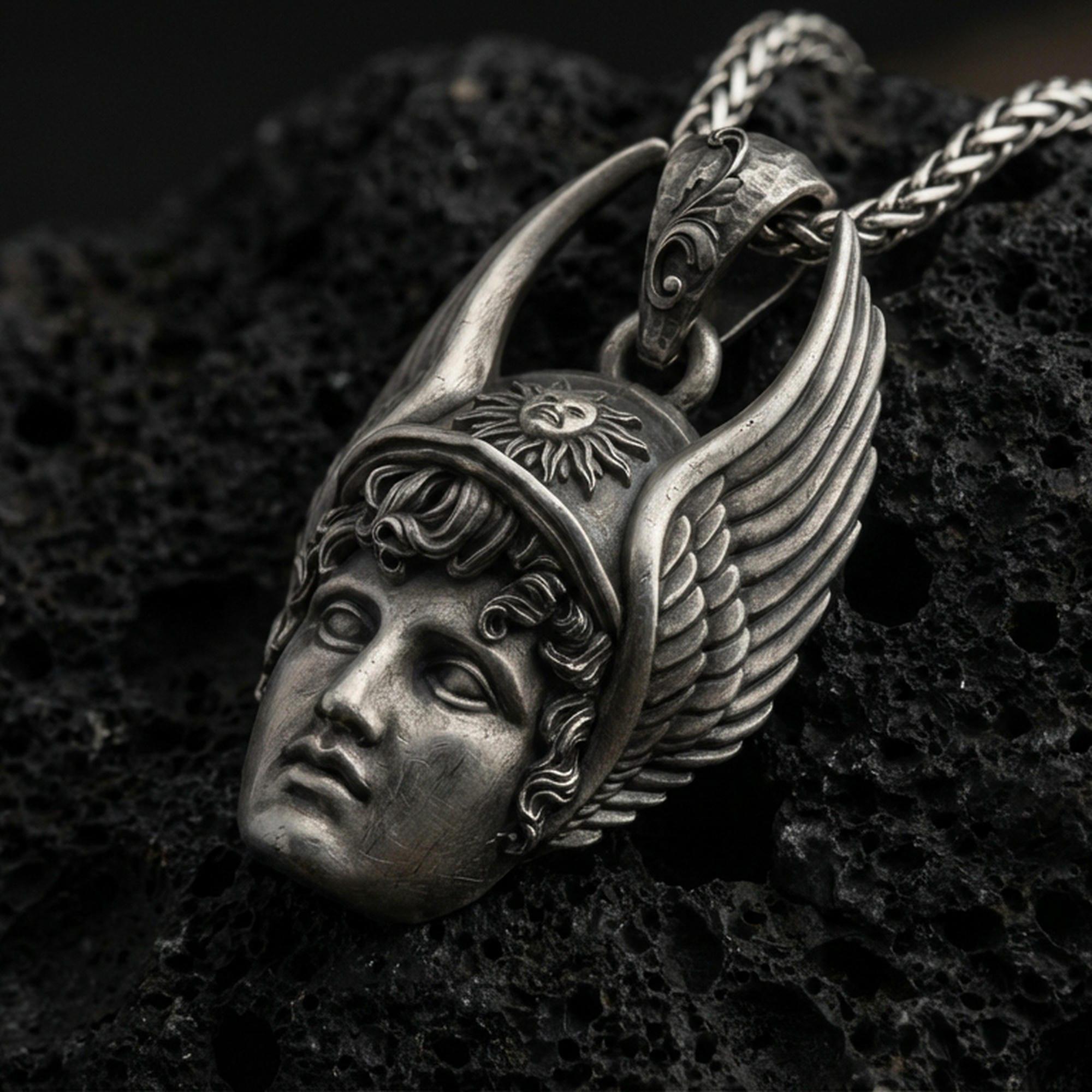 Oxidized Hermes pendant on textured volcanic rock, macro close-up, winged helmet face detail, dark premium studio lighting