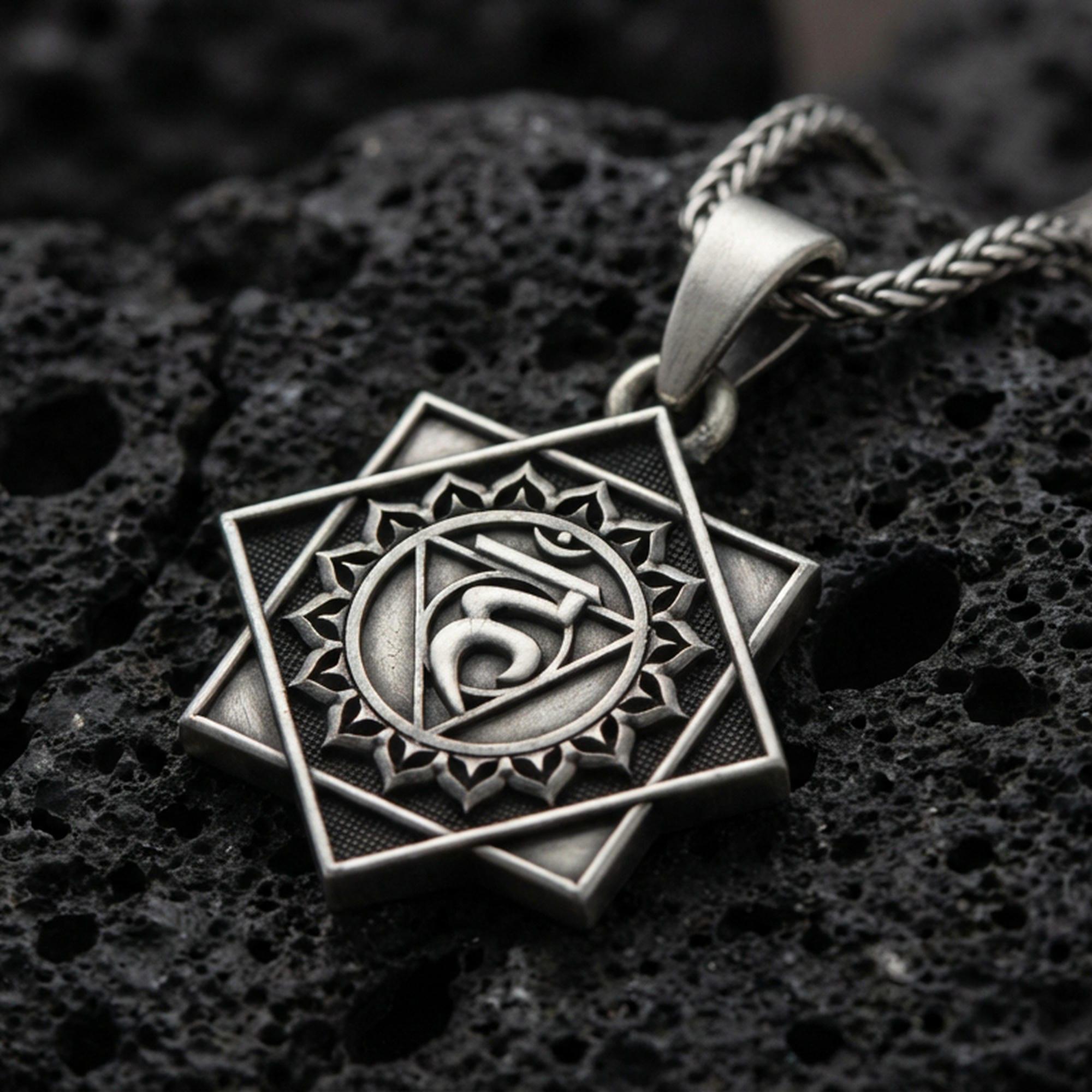 Oxidized Throat Chakra (Vishuddha) pendant on textured volcanic rock, macro close-up, geometric chakra symbol detail, premium studio lighting