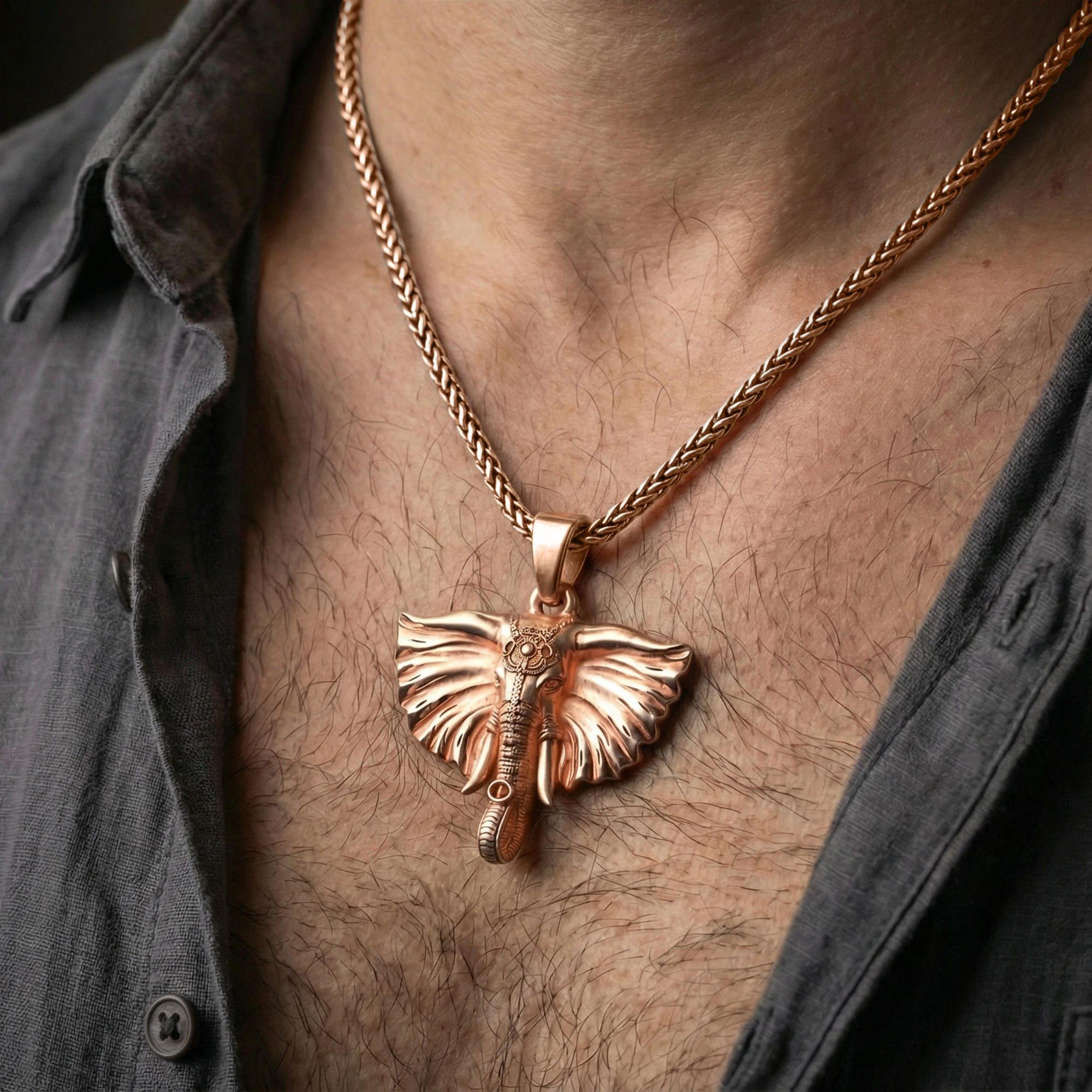 Rose gold plated elephant pendant necklace worn on neck, lifestyle composition with dark clothing, crisp elephant silhouette
