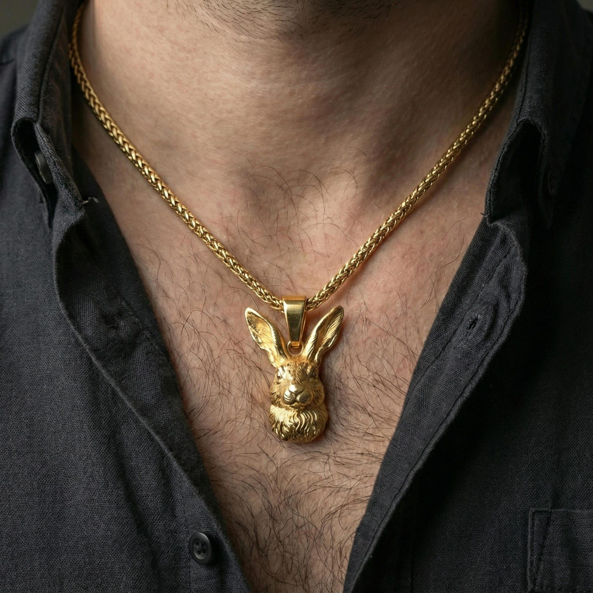 Gold plated rabbit necklace pendant worn on neck, close-up lifestyle shot, luxury lighting with refined metallic highlights