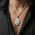 Load image into Gallery viewer, Polished silver Saint Joseph pendant on chain worn on neck, natural lifestyle framing, religious relief clearly visible
