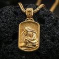Load image into Gallery viewer, Gold plated Virgin Mary Baby Jesus pendant displayed on porous volcanic rock surface, close-up studio composition, detailed background pattern and bail
