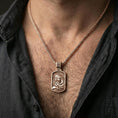Load image into Gallery viewer, Rose gold plated Mary and Child pendant necklace worn on neck, lifestyle composition with dark clothing, crisp rectangular silhouette
