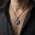 Load image into Gallery viewer, Oxidized Saint Uriel pendant necklace worn on neck, lifestyle close-up on dark outfit, angel medallion centered

