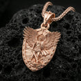 Load image into Gallery viewer, Rose gold plated Archangel Michael Orthodox pendant on volcanic rock, premium macro product photo, detailed wings, shield frame, and relief
