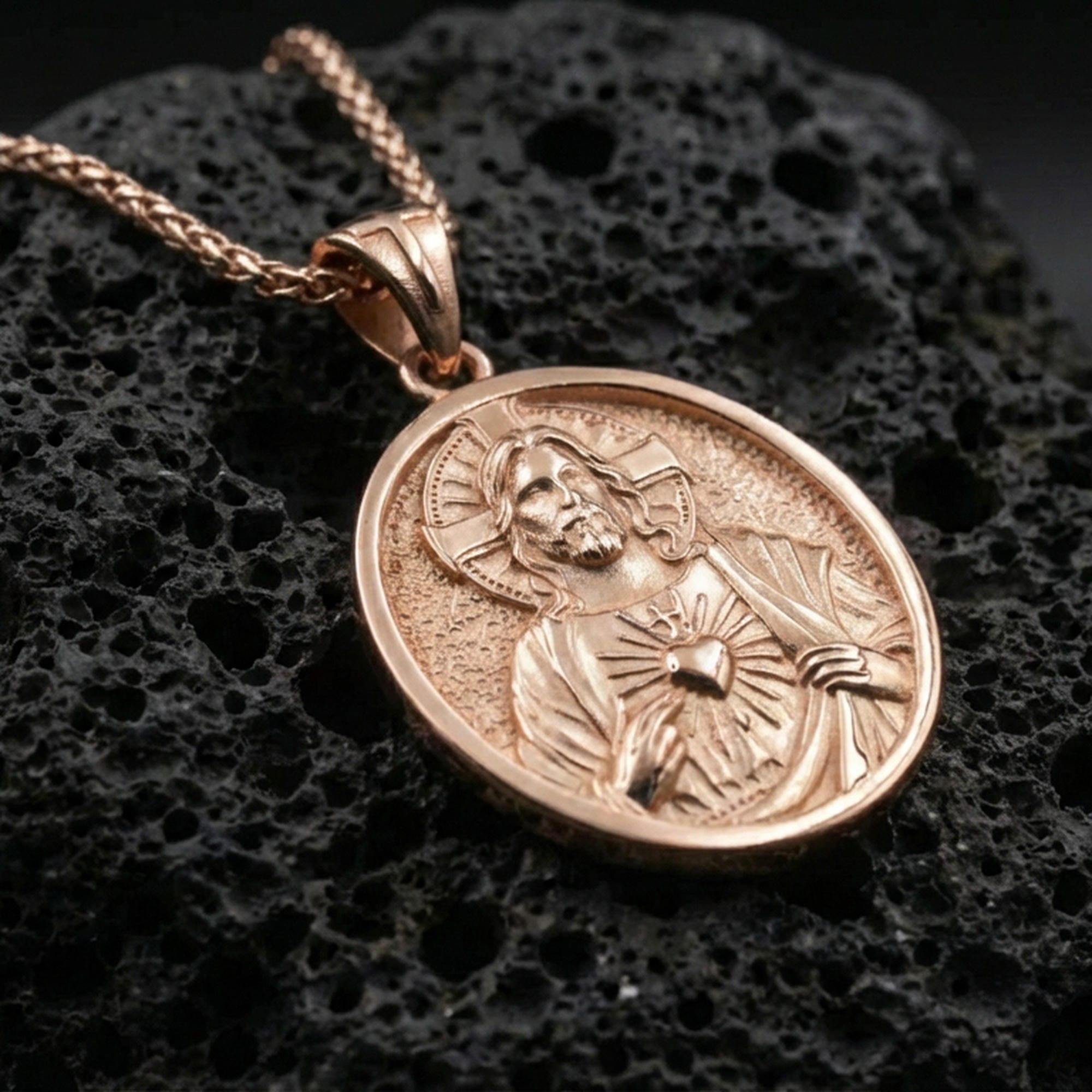 Rose gold plated Sacred Heart Jesus pendant on volcanic rock, premium macro product photo, sharp medal border and sacred heart motif