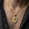 Load image into Gallery viewer, Gold plated Veiled Madonna necklace pendant worn on neck, close-up lifestyle shot, luxury lighting with refined metallic highlights
