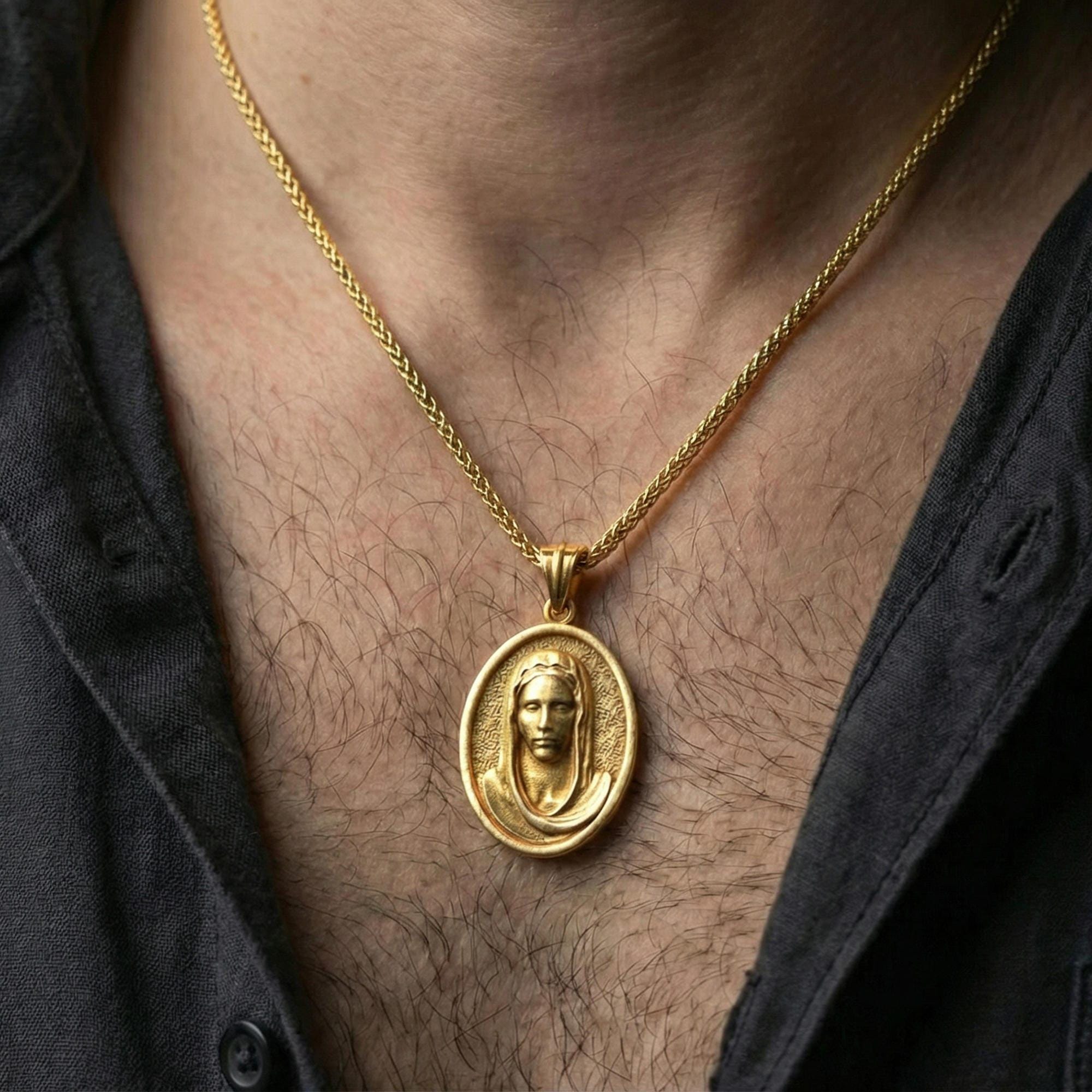 Gold plated Veiled Madonna necklace pendant worn on neck, close-up lifestyle shot, luxury lighting with refined metallic highlights