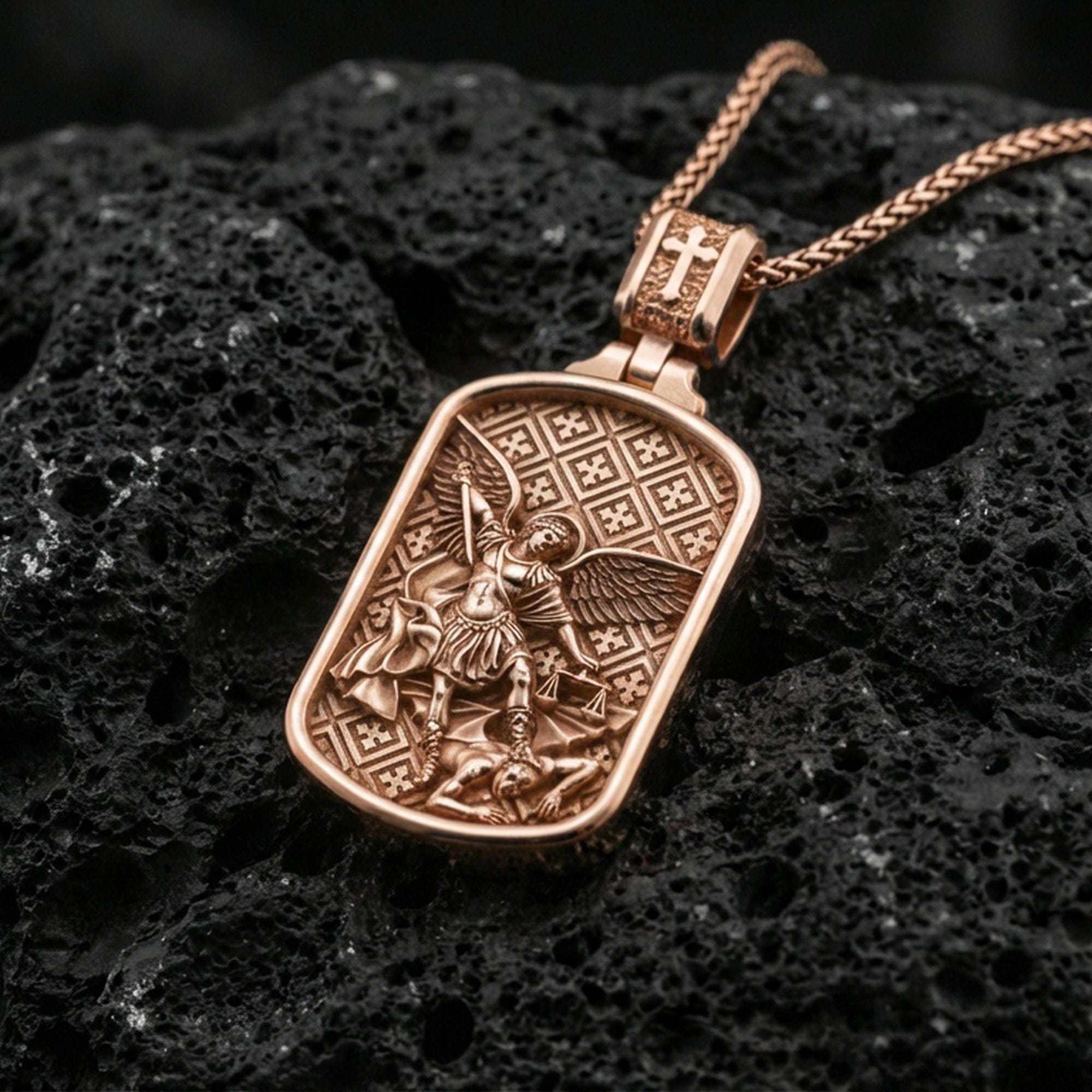 Rose gold plated Archangel Michael dogtag pendant on volcanic rock, premium macro product photo, sharp relief and clean rectangular silhouette