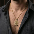 Load image into Gallery viewer, Gold plated Saint Roch dog tag necklace pendant worn on neck, close-up lifestyle shot, luxury lighting with refined metallic highlights
