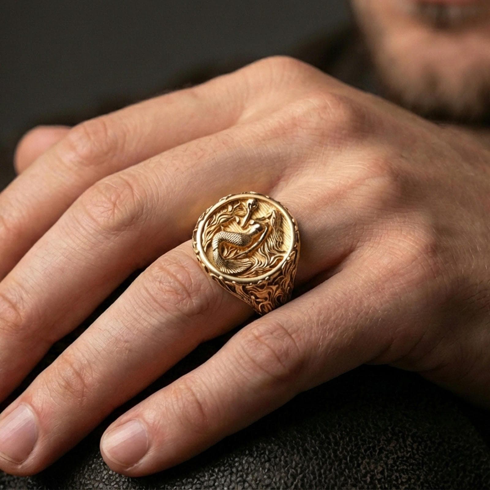 Gold plated mermaid ring worn on finger, warm highlights, ocean fantasy signet ring styling, statement jewelry shot