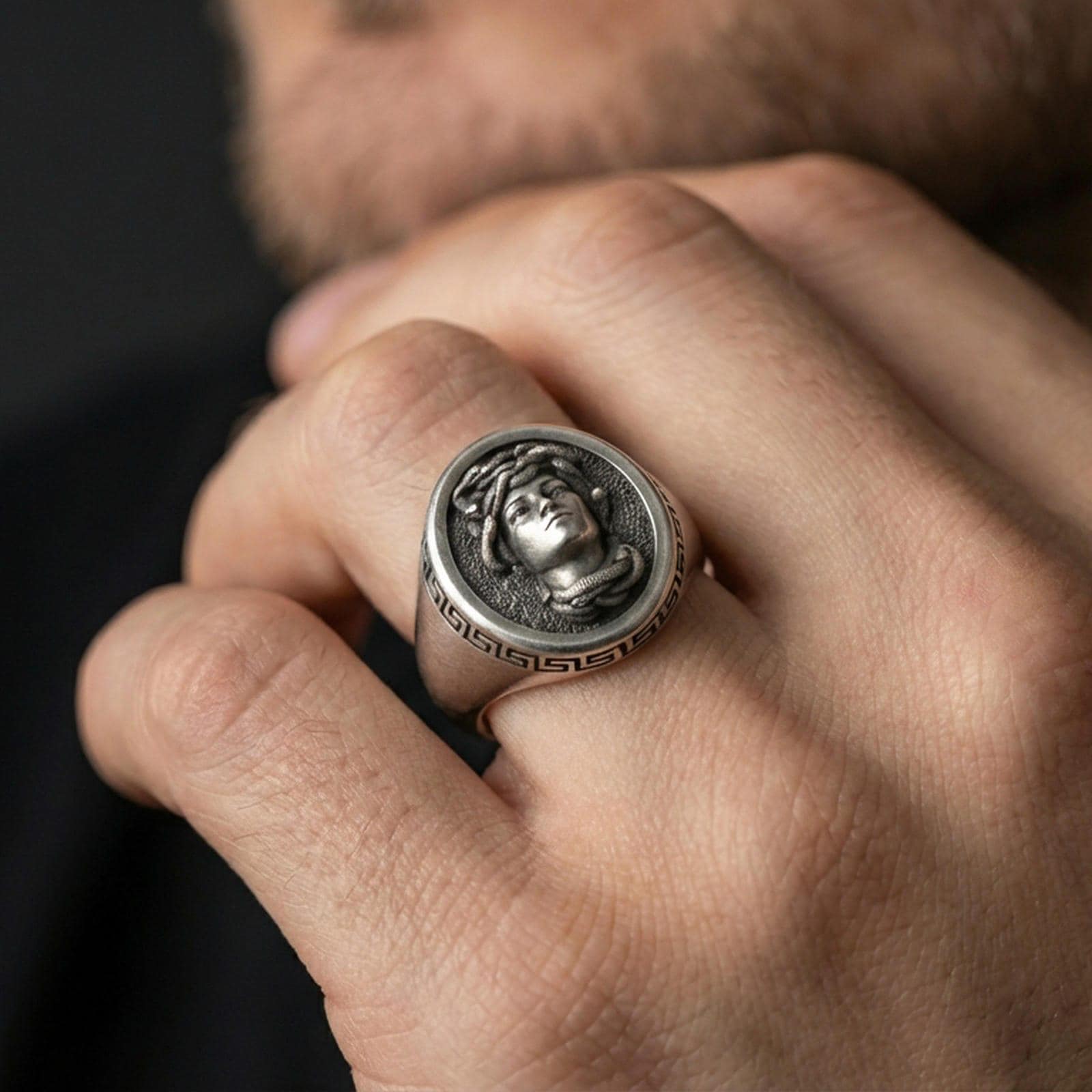 Oxidized Medusa signet ring worn on hand, bold Greek mythology jewelry look with Greek key border
