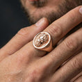 Load image into Gallery viewer, Rose gold plated Poseidon ring on hand, close-up lifestyle framing, detailed king portrait signet, elegant myth jewelry aesthetic
