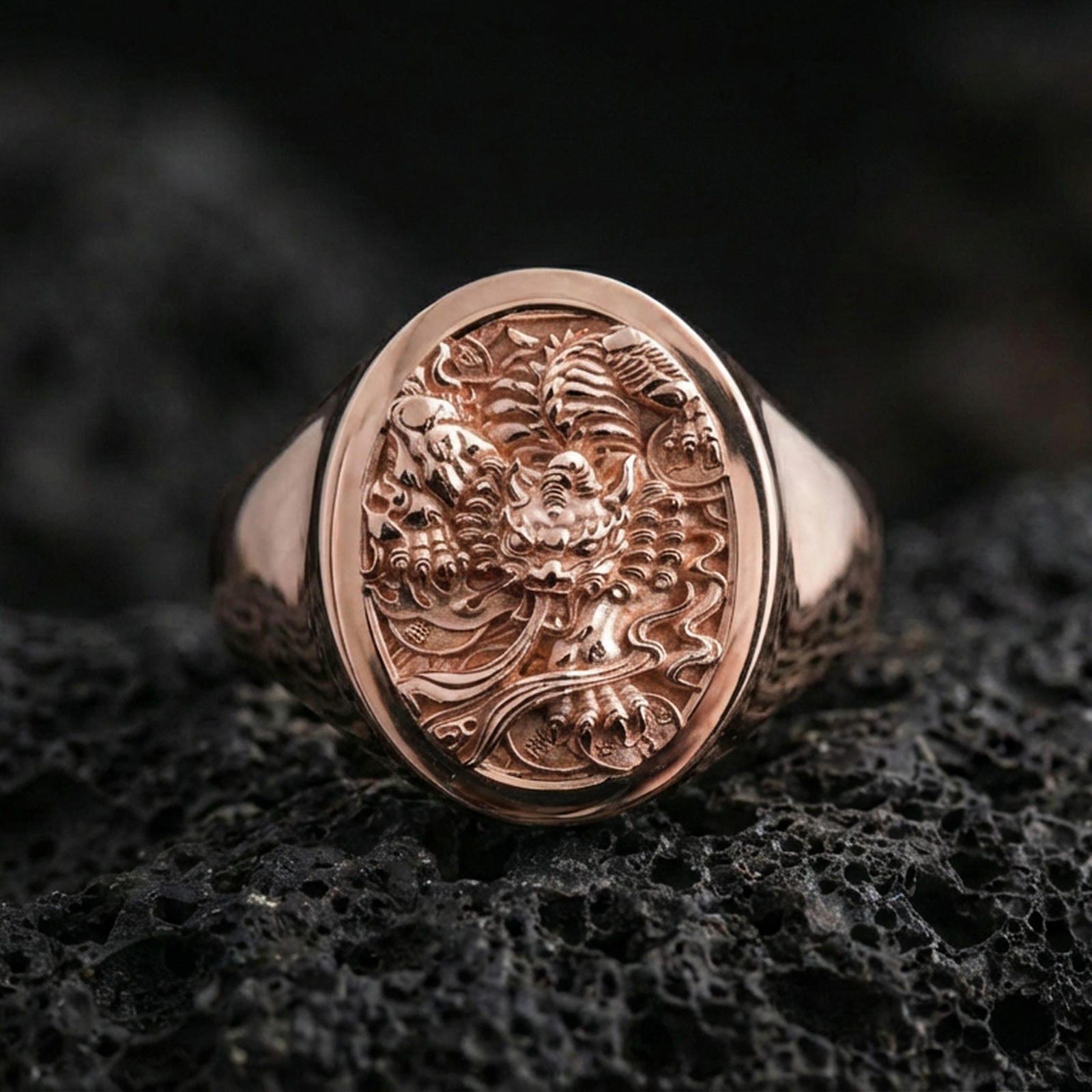 Rose Gold Plated: Rose gold plated signet ring featuring ornate yokai-style relief on volcanic rock, luxury close-up shot