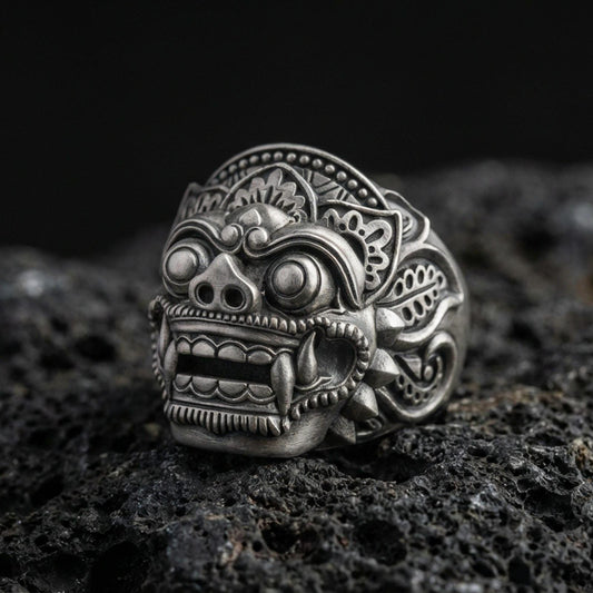 Balinese Barong god sterling silver ring in an oxidized finish on volcanic rock, macro studio product photo