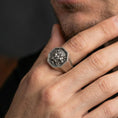 Load image into Gallery viewer, Octagon sterling silver oxidized Foo Dog signet ring worn on finger, Chinese guardian lion relief visible, lifestyle hand close-up
