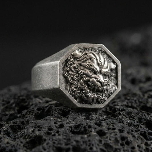 Octagon sterling silver Foo Dog signet ring in an oxidized finish on volcanic rock, Chinese guardian lion relief, macro studio product shot