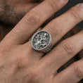 Load image into Gallery viewer, Sterling silver Freya Viking ring in an oxidized finish worn on finger, oval Norse goddess relief visible, lifestyle hand close-up
