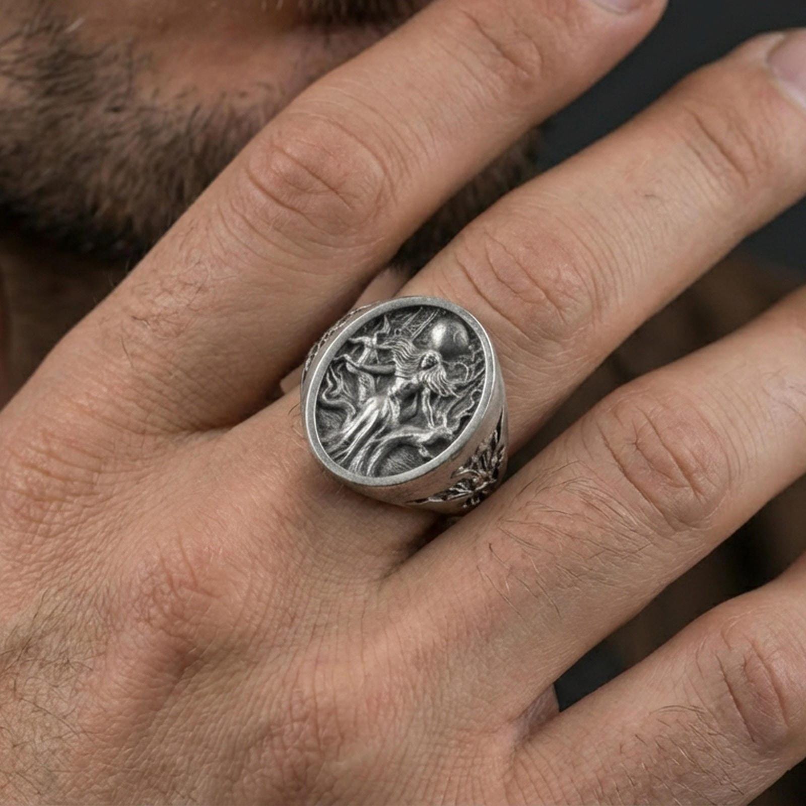 Sterling silver Freya Viking ring in an oxidized finish worn on finger, oval Norse goddess relief visible, lifestyle hand close-up
