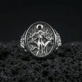 Load image into Gallery viewer, Sterling silver Freya ring in polished silver finish on volcanic rock, detailed Norse mythology goddess relief, close-up photo
