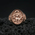 Load image into Gallery viewer, Freya Viking ring in a rose gold plated finish on volcanic rock, ornate Norse goddess Freyja engraving detail, luxury studio close-up

