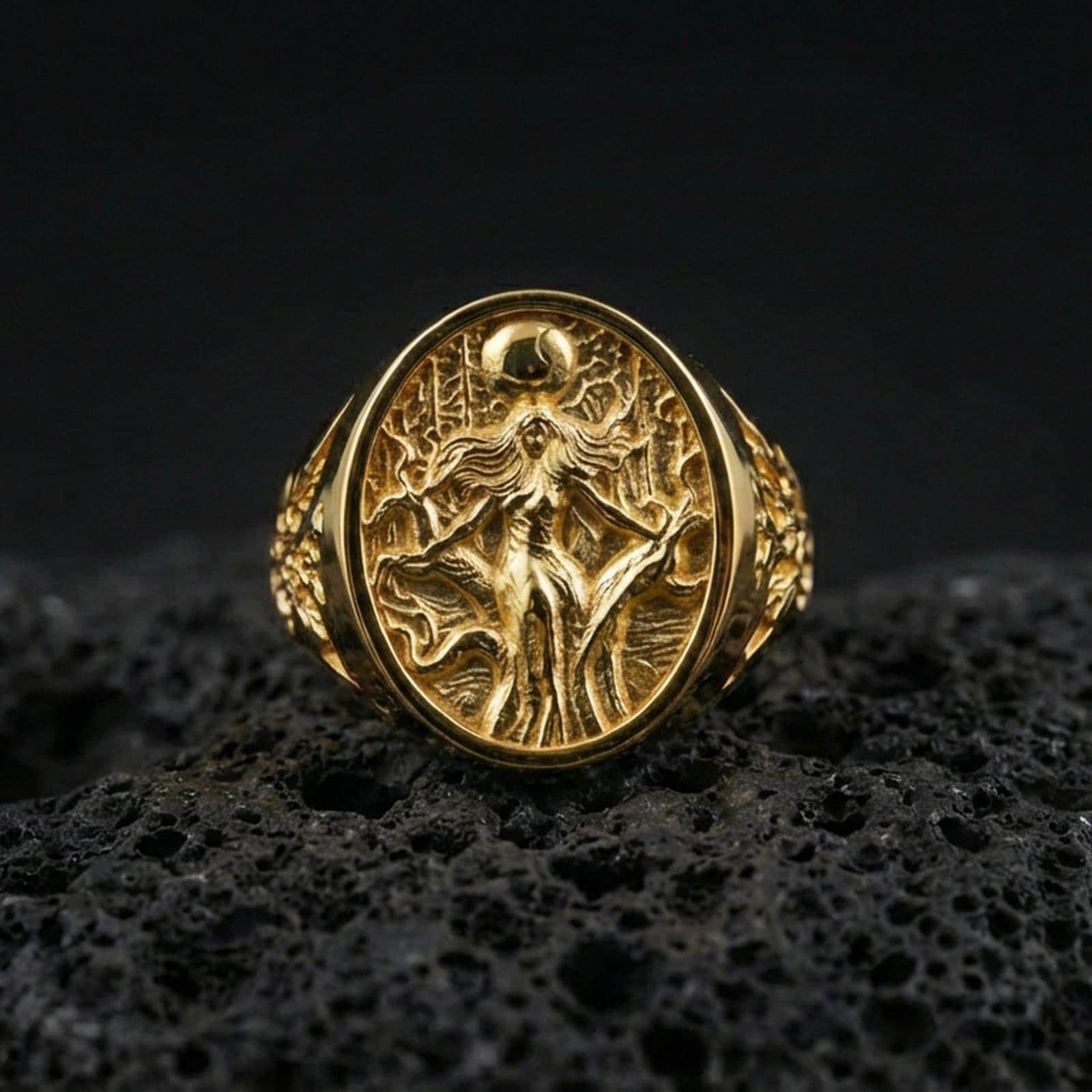 Freya Viking ring in a gold plated finish on volcanic rock, oval signet with Norse goddess design, premium macro product image