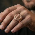 Load image into Gallery viewer, Odin ring in a rose gold plated finish on finger, detailed knotwork signet face, lifestyle wear photo
