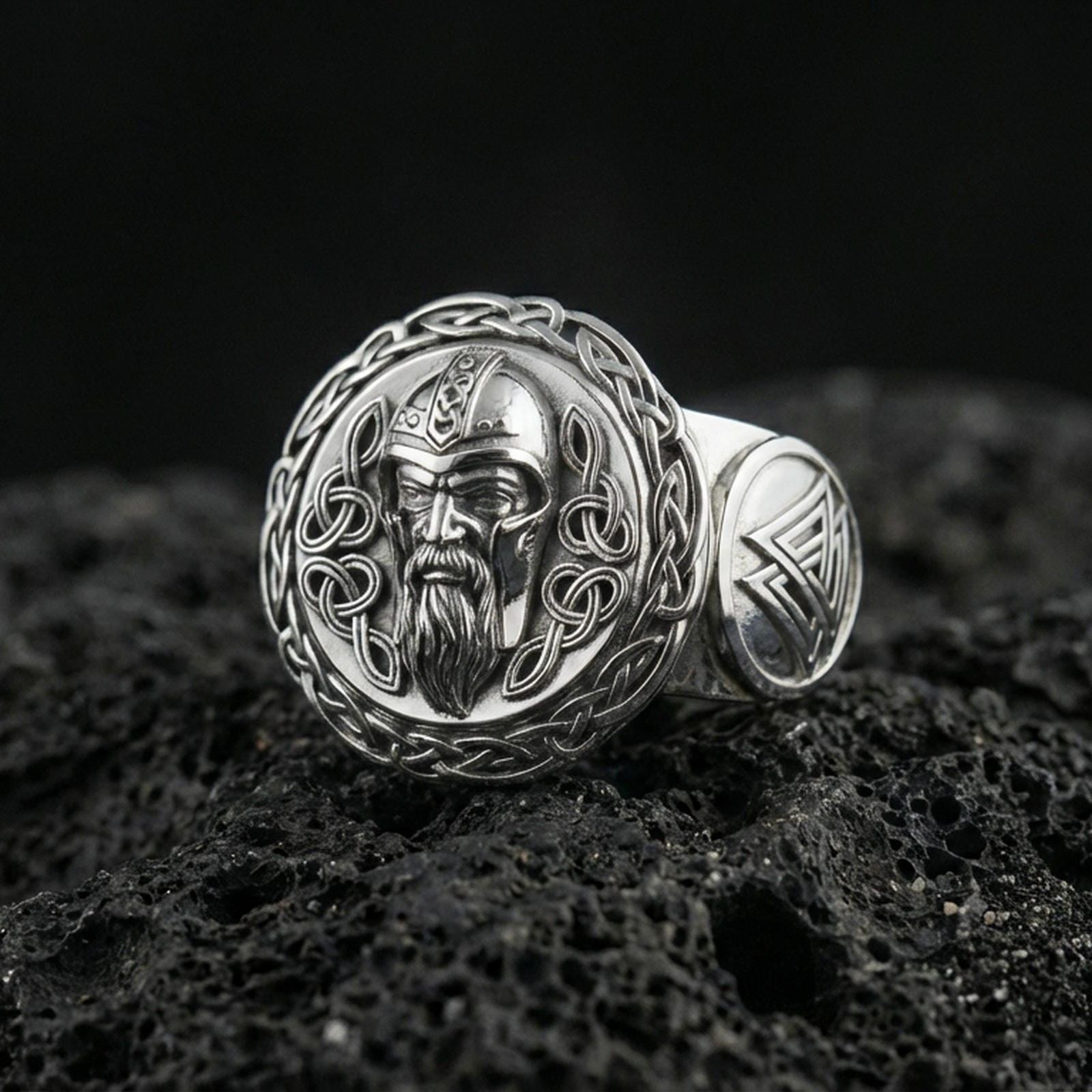 Odin the All-Father ring in polished silver finish on volcanic rock, Norse mythology signet with braided knotwork detail, close-up photo