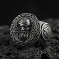 Load image into Gallery viewer, Odin the All-Father sterling silver ring in an oxidized finish on volcanic rock, Viking warrior portrait with Celtic knot border, macro studio product shot
