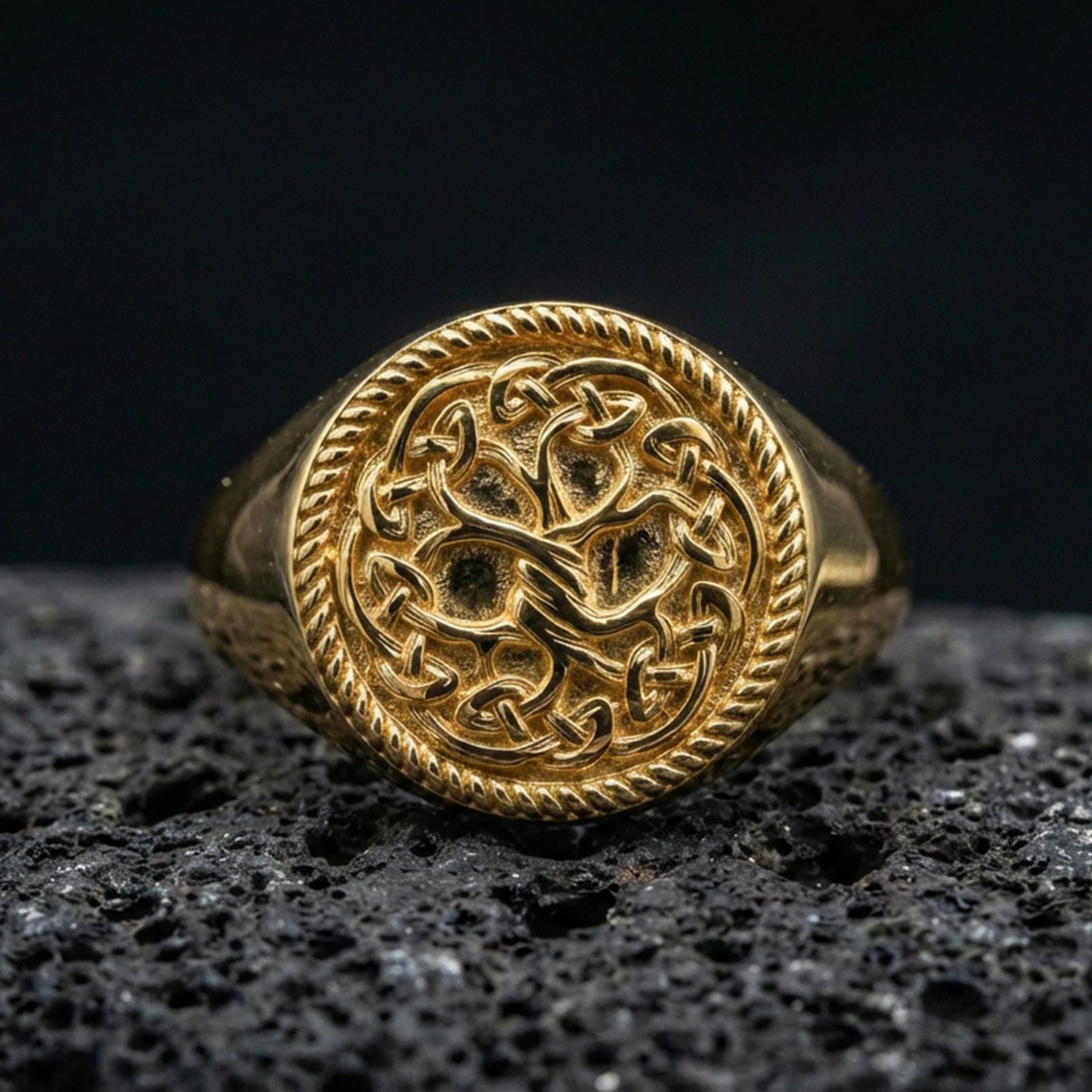 Yggdrasil Tree of Life ring in a gold plated finish on volcanic rock, Viking knotwork signet design, premium macro product image