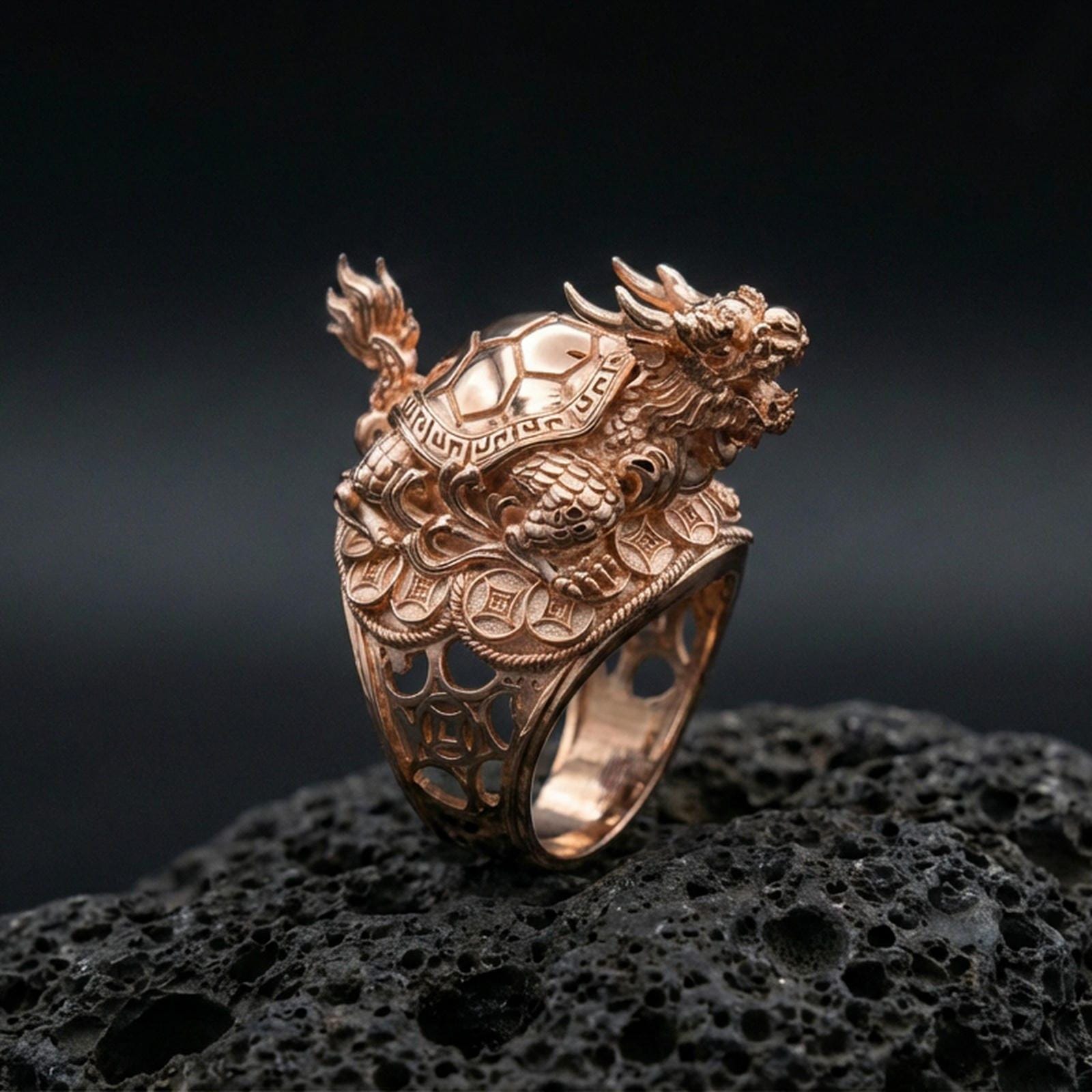Dragon turtle ring in a rose gold plated finish on volcanic rock, ornate dragon head and turtle shell details, luxury studio close-up