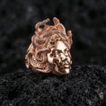 Load image into Gallery viewer, Medusa ring in a rose gold plated finish on volcanic rock, ornate Greek mythology gorgon portrait with snakes, luxury studio close-up
