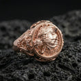 Load image into Gallery viewer, Fenrir wolf signet ring in a rose gold plated finish on volcanic rock, ornate wolf head relief with Celtic-inspired detailing, luxury studio close-up
