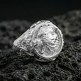 Load image into Gallery viewer, Fenrir wolf ring in polished silver finish on volcanic rock, detailed Norse wolf portrait with ornamental border and side scrollwork, close-up product photo
