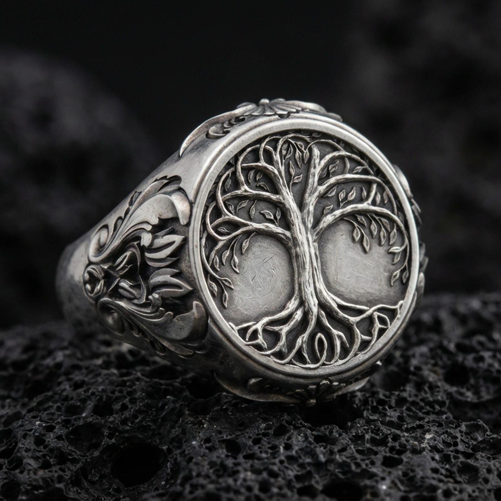 Sterling silver Yggdrasil tree of life signet ring in an oxidized finish on volcanic rock, Celtic-inspired branches and roots relief, macro studio product shot