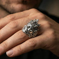 Load image into Gallery viewer, Yama god of death mask ring in polished silver finish on finger, sharp facial contours and engraved crown details, lifestyle wear shot

