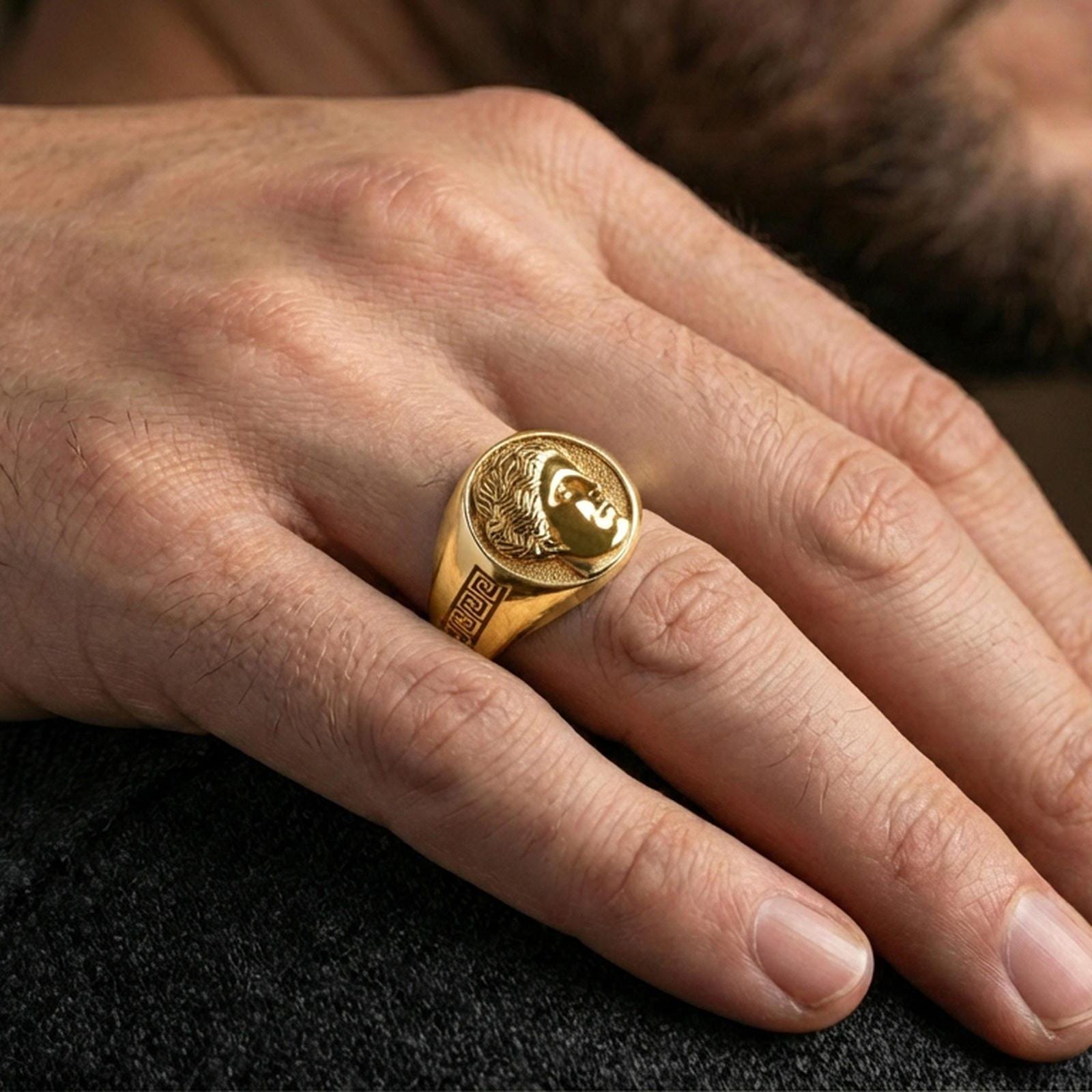 Venus goddess ring in a gold plated finish worn on finger, classical Roman love deity profile engraving, premium jewelry lifestyle photo
